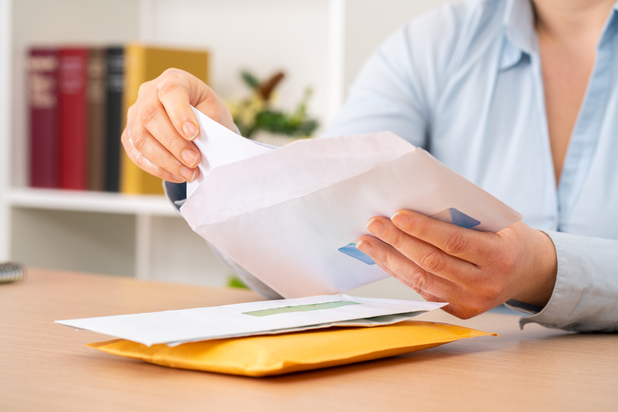 Employee stuffing envelopes for their company’s direct mail campaigns.
